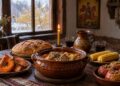 Празнична трапеза за Димитровден с гювеч, печена тиква, варена царевица и икона на свети Димитър на червен кон